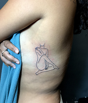 body outline tattoo on rib