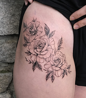 blackwork flower tattoo on thigh