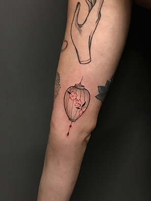 lantern tattoo on forearm