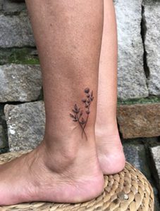 blackwork leave branch tattoo