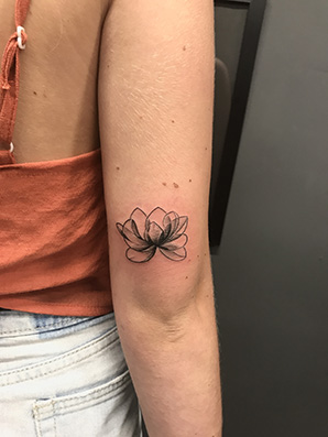 blackwork lotus tattoo on arm