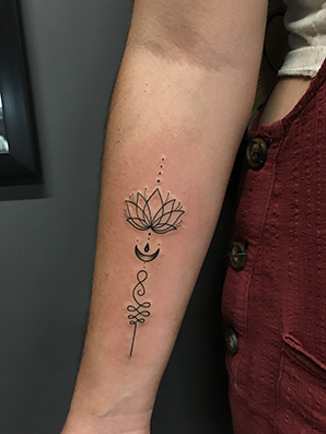 lotus unalome tattoo on forearm