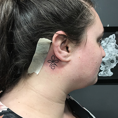 symbol tattoo on neck