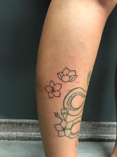 Sampaguita flower tattoo located on the side boob