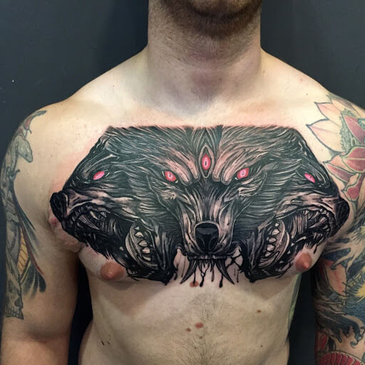 Wolf tattoo on the left shoulder and chest