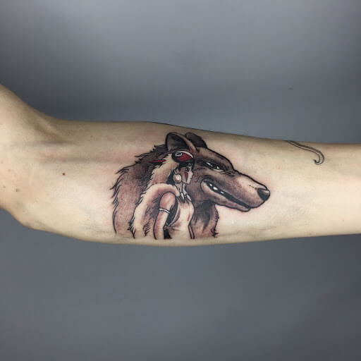 Double exposure winter wolf tattoo on the left inner