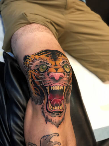 Yellow tiger tattoo on leg