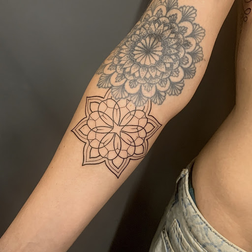 Mandala tattoo on Amy's left inner forearm.