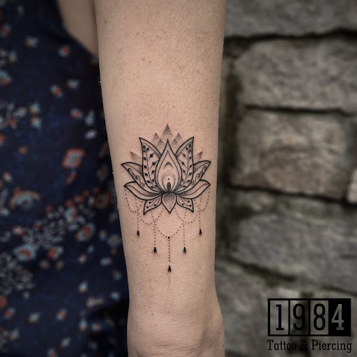 Ornamental mandala tattoo on the inner forearm